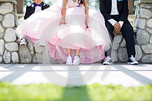 Closeup of a quinceanera/sweet 16 celebrant with pink dress and two boys on each side