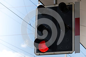 Closeup railroad signal red light platform against sky