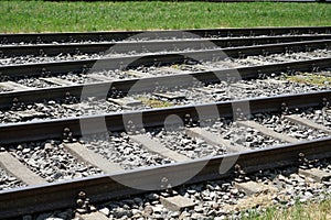 Closeup of railroads on background of grass