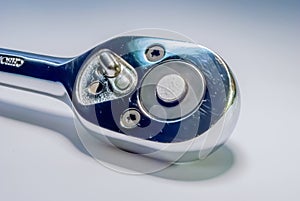 Closeup of a ratchet socket wrench on white background
