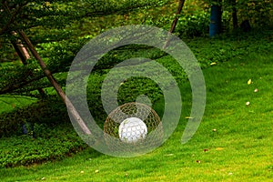 Closeup of rattan white floor lamp on the grass in the park