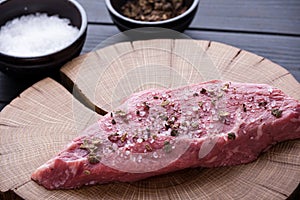 Closeup raw beef steak with spices