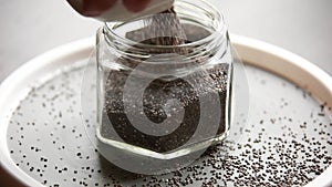 closeup raw chia seed in a white bowl on the table