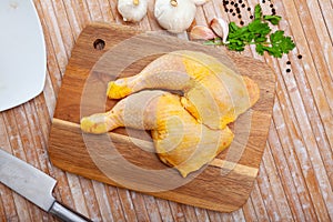 Closeup of raw chicken legs with garlic