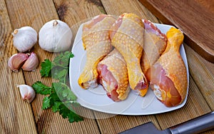 Closeup of raw chicken legs with garlic