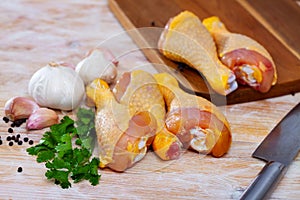 Closeup of raw chicken legs with garlic