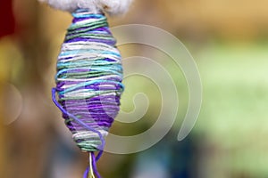Closeup raw colorful Thai cotton tread over blurred background