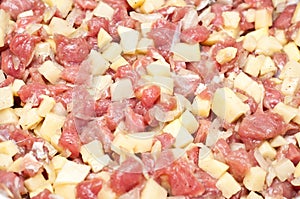 Closeup of raw diced meat and potatoes