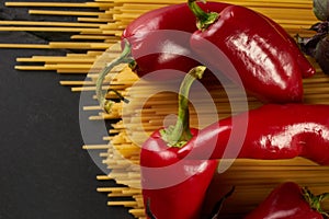 Closeup of raw spaghetti bavette with tomatoes, bell pepper