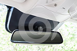 Closeup of rear view mirror in modern car interior