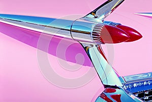 Closeup of red backlights of a pink shiny retro car under the lights photo
