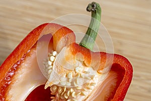 Closeup of red bell pepper sliced in half, seeds and juicy flesh