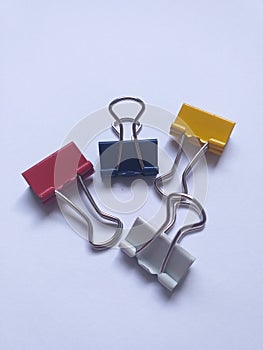 Closeup of red, blue and yellow binder clips