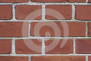 Closeup of a red brick wall of a house or home. Background of clean, modern, rustic, building and masonry. Historic