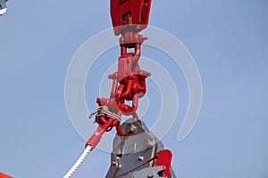 Closeup of a red chain pulley outdoors during dayligh