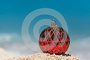 Closeup of Red Christmas Ball on the Tropical Beach, Winter Holiday Concept