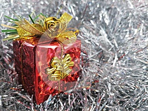 Closeup red christmas gift box on a silver background.