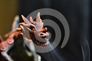 Closeup of Red Dragon Breathing Smoke