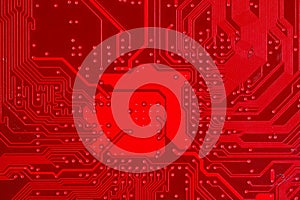 Closeup of red electronic motherboard circuit with processor