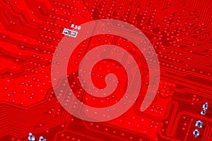 Closeup of red electronic motherboard circuit with processor