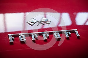 Closeup of red ferrari 250 GT logo