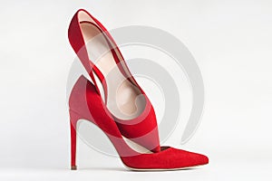 Closeup of red high heels on white background