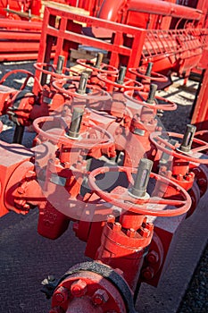 Closeup of a red industrial oil pipeline valves