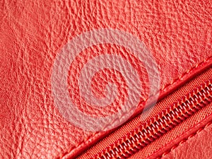 Closeup of red leather background with zipper, cope space