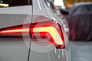 Closeup of a red led taillight on a modern car, detail on the rear light of a car