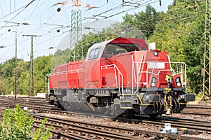 Closeup of a red modern freight locomotive during dayli