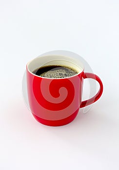 Closeup of a Red Mug filled with Black Coffee isolated on White