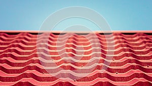 Closeup of red roof texture tile with blue sky