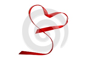 Closeup red satin ribbon or tape in heart shape, isolated on white background. Concept Valentine`s Day, wedding anniversary,