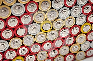 Red and silver aa alkaline batteries stack on full frame