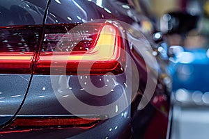 Closeup of a red taillight on a modern car, detail on the rear light of a car