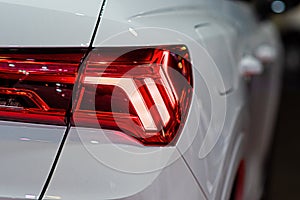 Closeup of a red taillight on a modern car, detail on the rear light of a car