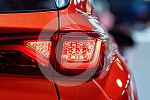 Closeup of a red taillight on a modern car, detail on the rear light of a car