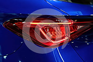 Closeup of a red taillight on a modern car, detail on the rear light of a car