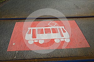 Closeup of red white old vintage tram car sign on asphalt between rails - Germany