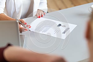 Closeup of resume laying on the office table in front of HR