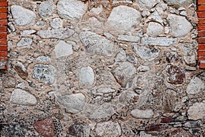 Closeup of retaining wall made of stones and boulders.