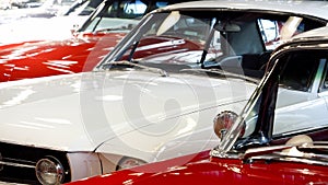 Closeup of retro cars pained in red and white. Details of automobiles