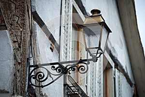 retro street light on medieval house facade in the street