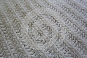 Closeup of rib stitch pattern on white knitwork diagonal wales