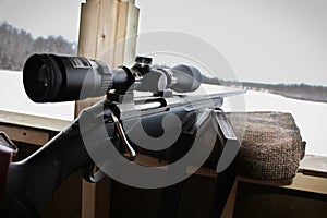 Closeup of a rifle bolt and scope while hunting