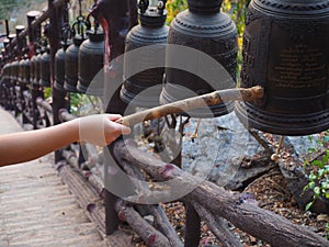 Closeup ringing a bell in a Buddhist temple