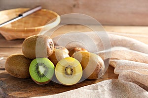 Closeup ripe golden kiwi fruit and green kiwi fruit on wooden background. Healthy fruits concept