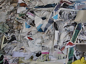 Closeup of ripped paper and staples remaining from multiple fliers on a bulletin board