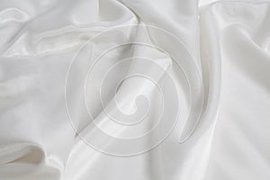 Closeup of rippled white silk fabric background