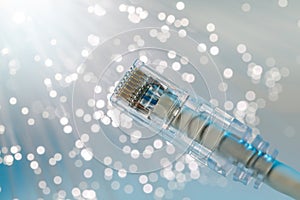 Closeup of RJ45 UTP LAN on the background of optical fibers with blurred lights